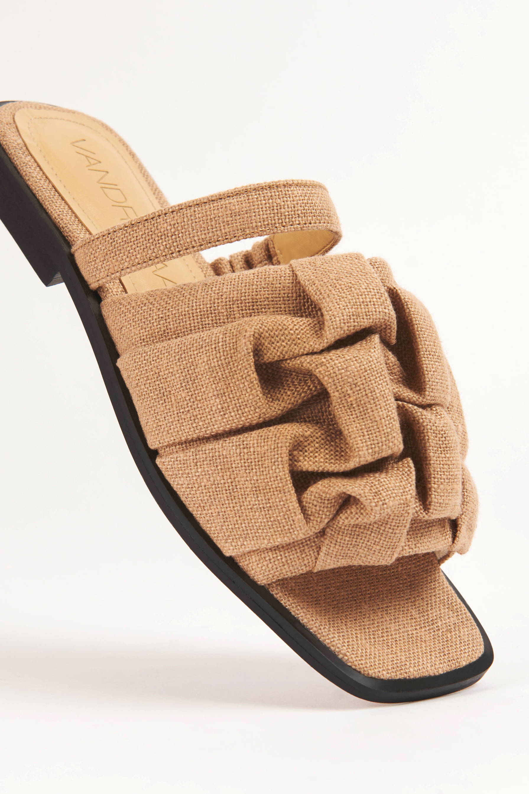 Closeup of Vandrelaar vegan Simone sandal in sandy beige linen featuring canadian smocking detailing and square toe