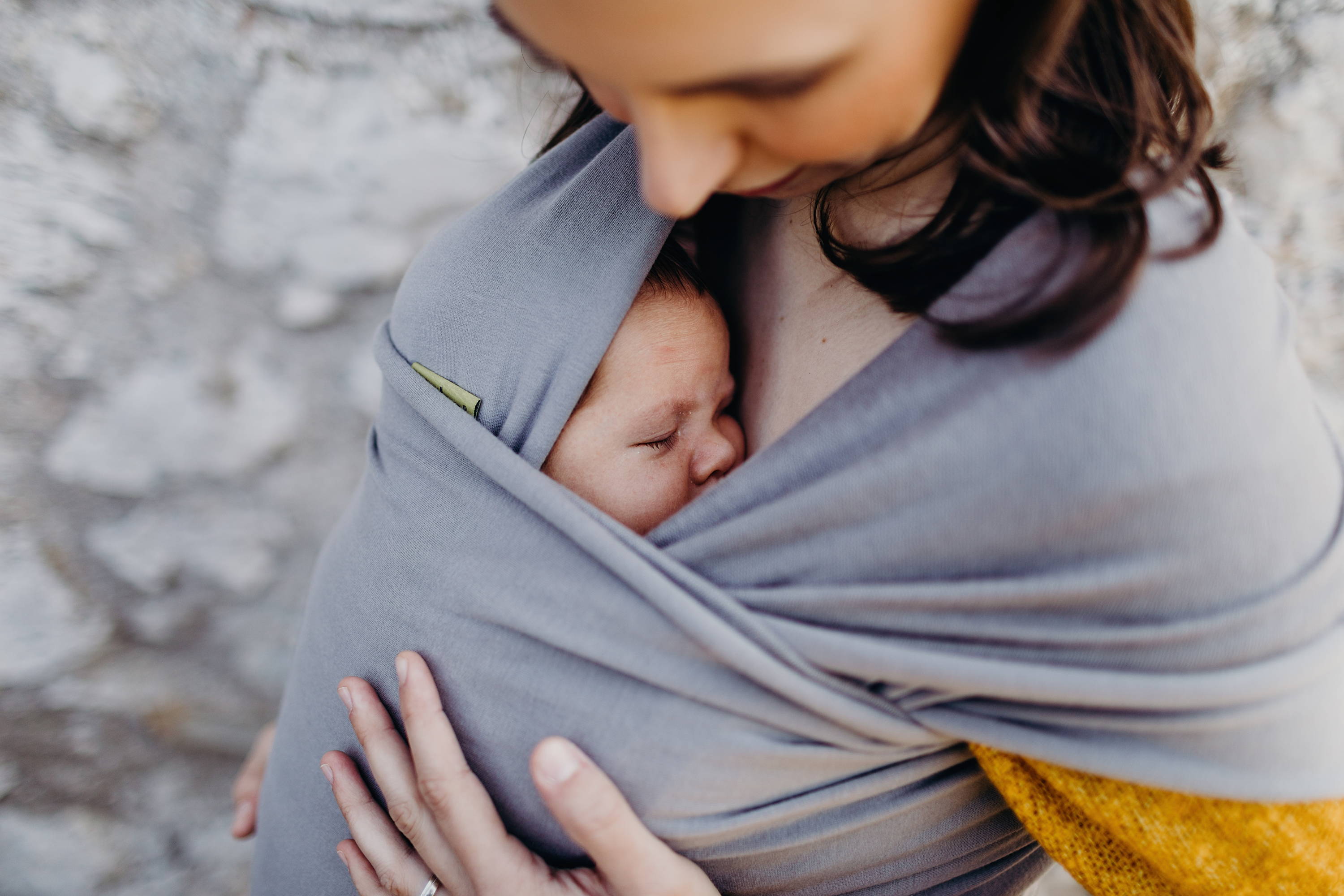 Newborn baby sleeping on confident mom's chest
