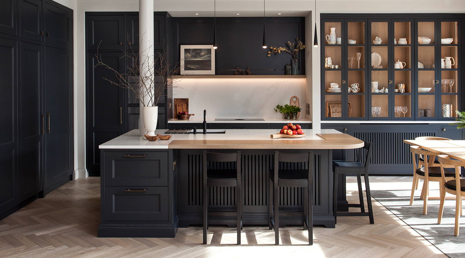 Navy kitchen design by Michael Farrell. Kitchen finished with brass handles, wood flooring and accents and marble worktops