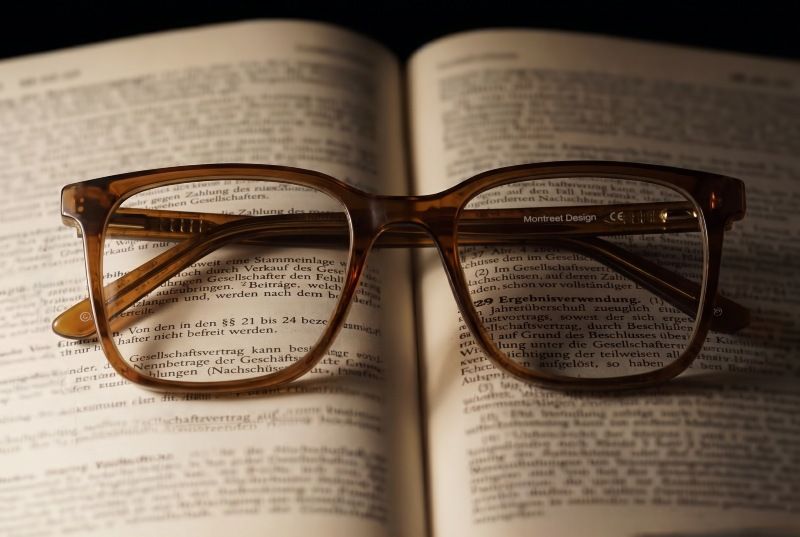 Glasses for farsightedness placed on an open book