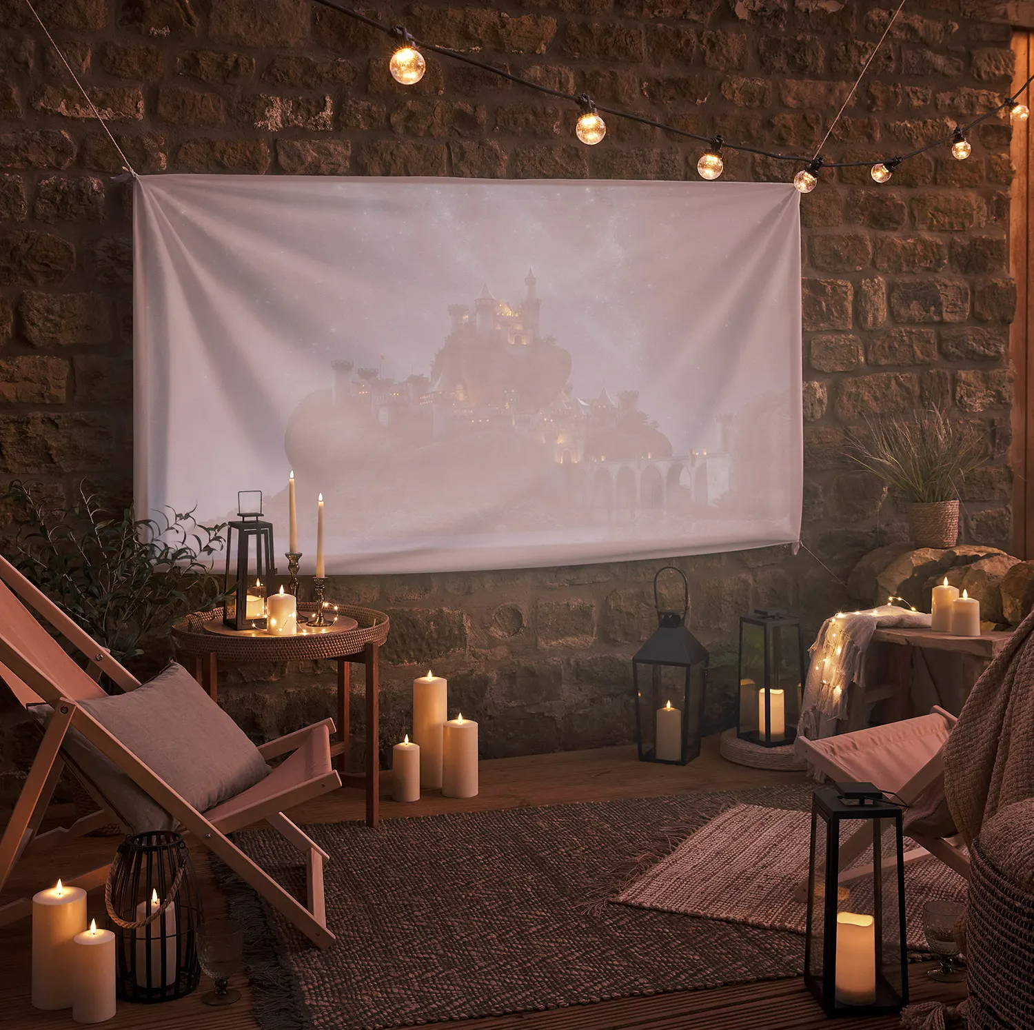 An outdoor movie night set up with festoons, lanterns and outdoor LED candles.
