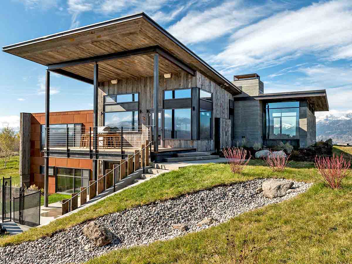 Grey, vertical reclaimed wood siding and soffits on a modern home in Teton mountain range in Wyoming.|gallery_img product_siding laramie_color use_walls application_exterior type_residential