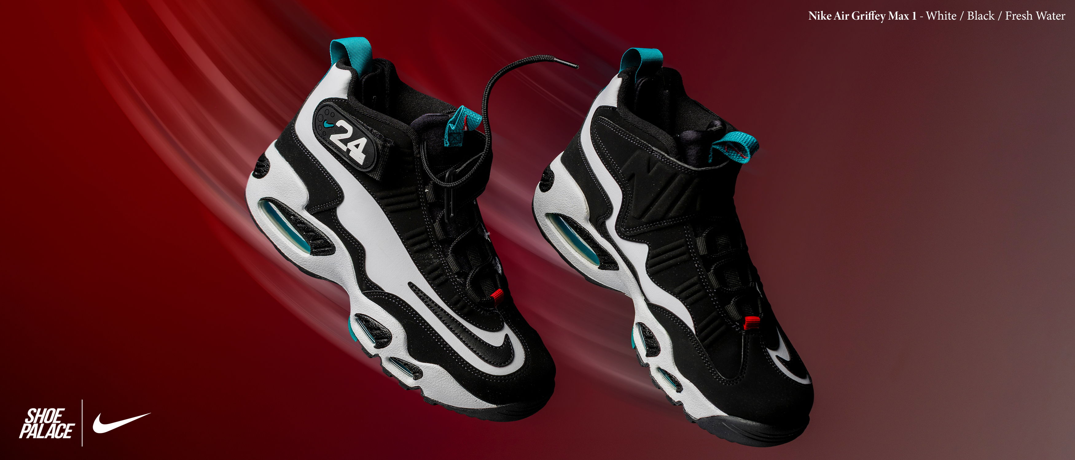 Black and white Nike sneakers with turquoise accents on a red background.