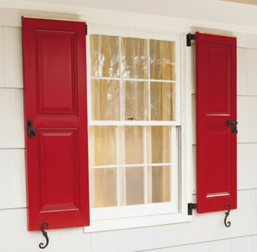 Red window shutters flanking a white window with a light background.