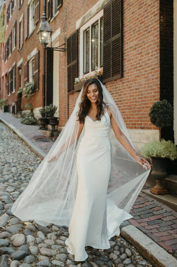 Bride wearing the Grace Loves Lace honey silk gown and long tulle veil