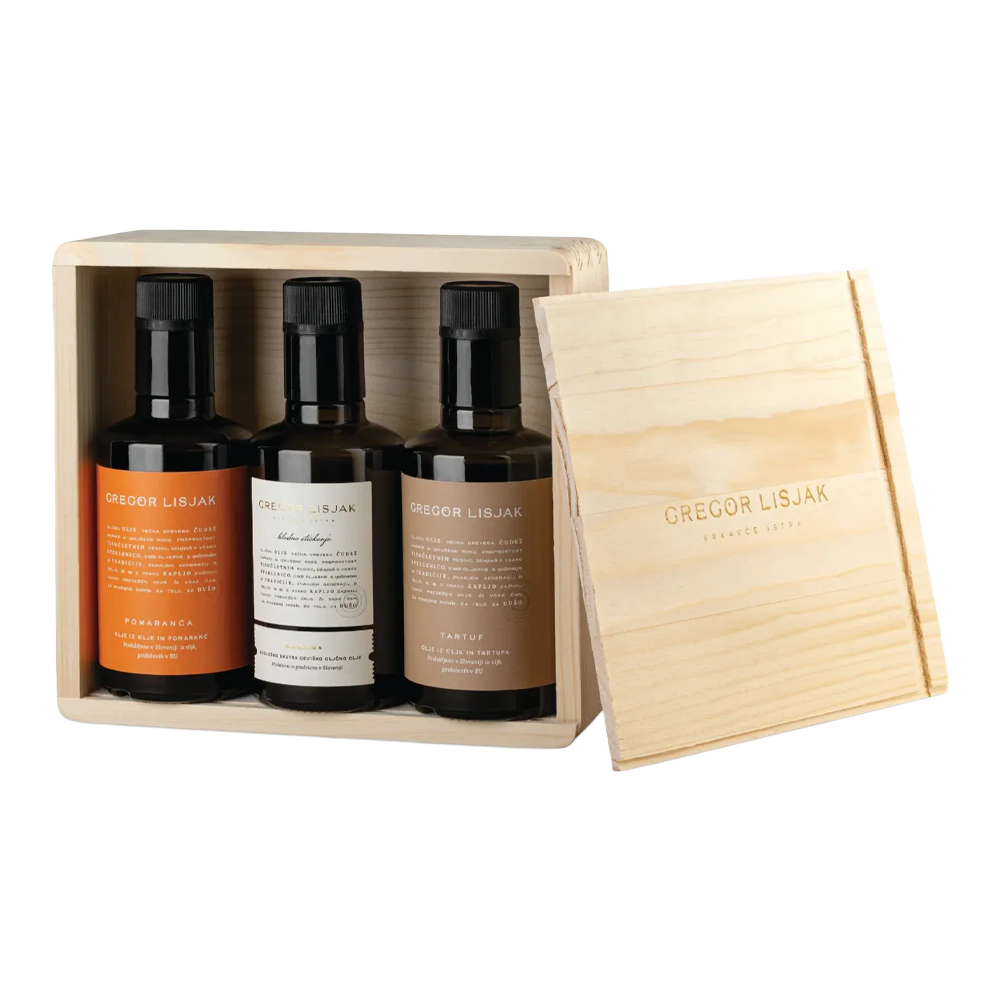 Three bottles in a wooden box with a sliding lid.