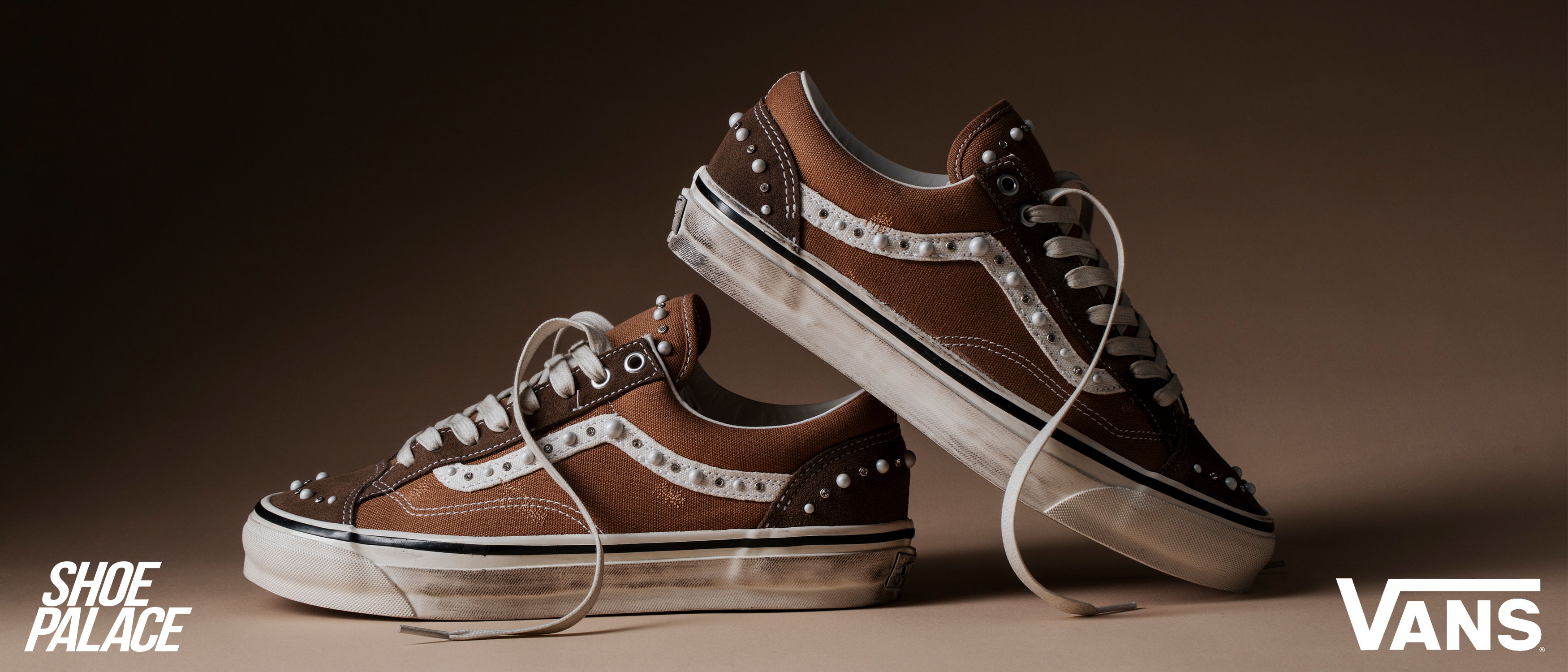 A pair of brown Vans sneakers on a neutral background.