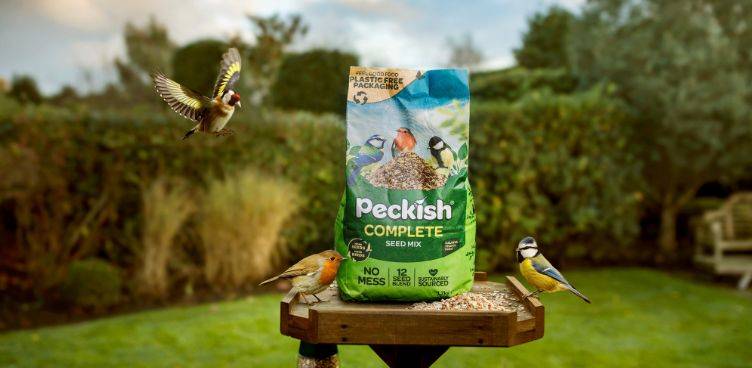 Peckish Complete Packaging on  bird table with birds flying