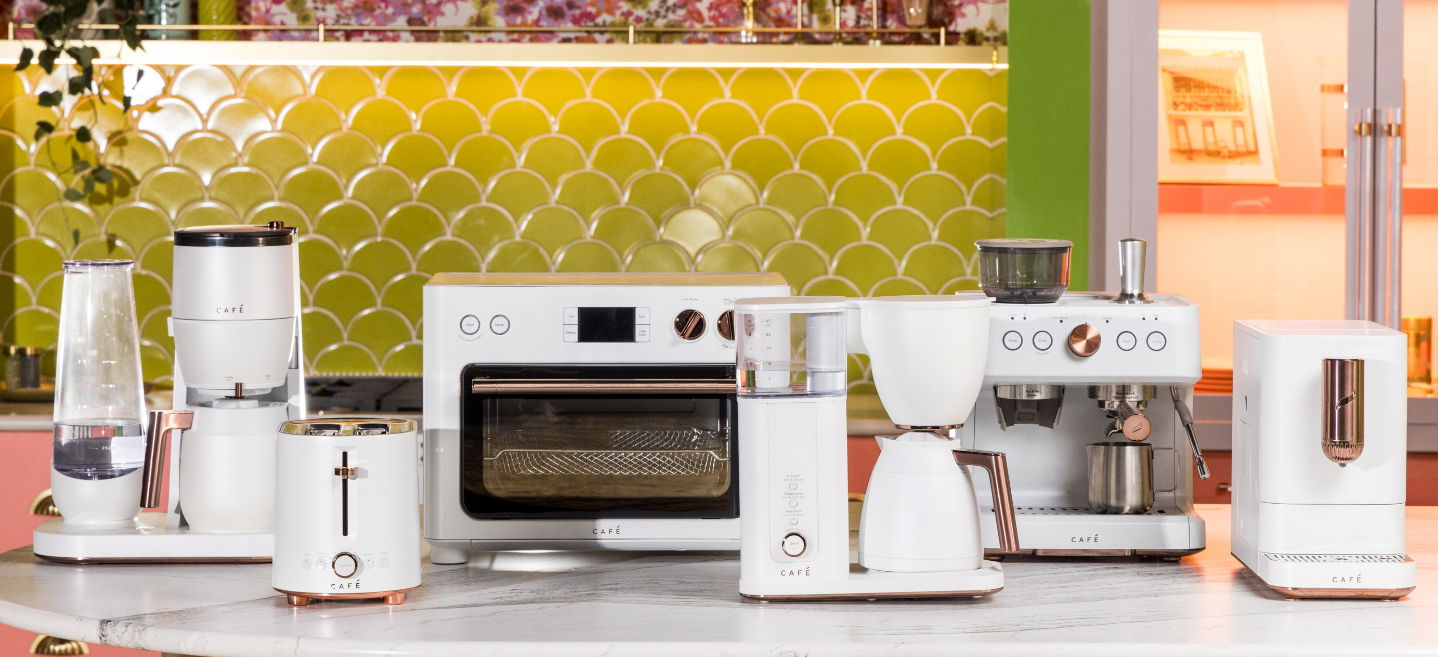 A collection Cafe of modern white kitchen appliances on a countertop.
