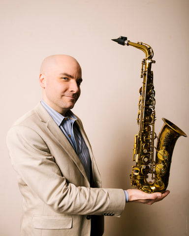 Rulon Brown holding an alto saxophone