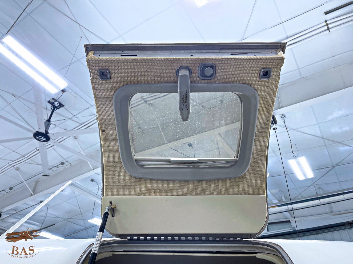 Open aircraft hatch showing interior details and surrounding structure.