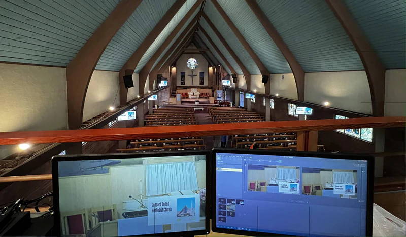 Church livestream control position with monitors overlooking the sanctuary