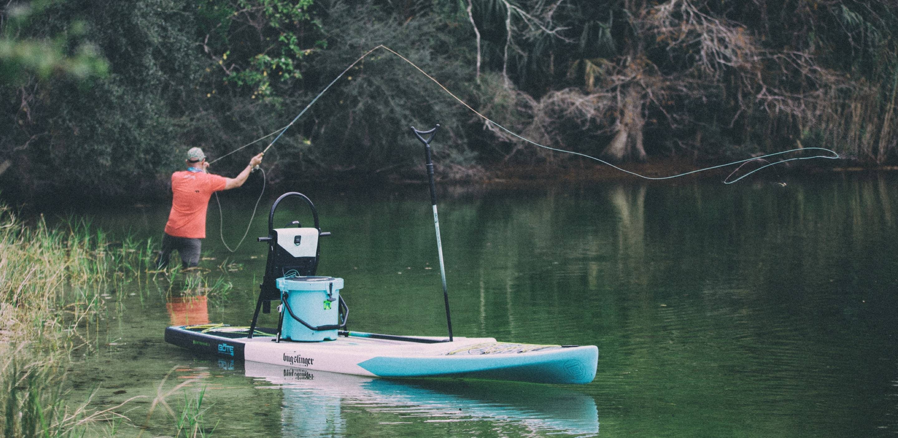 Man fly fishing on the Bug Slinger Silver King paddle board