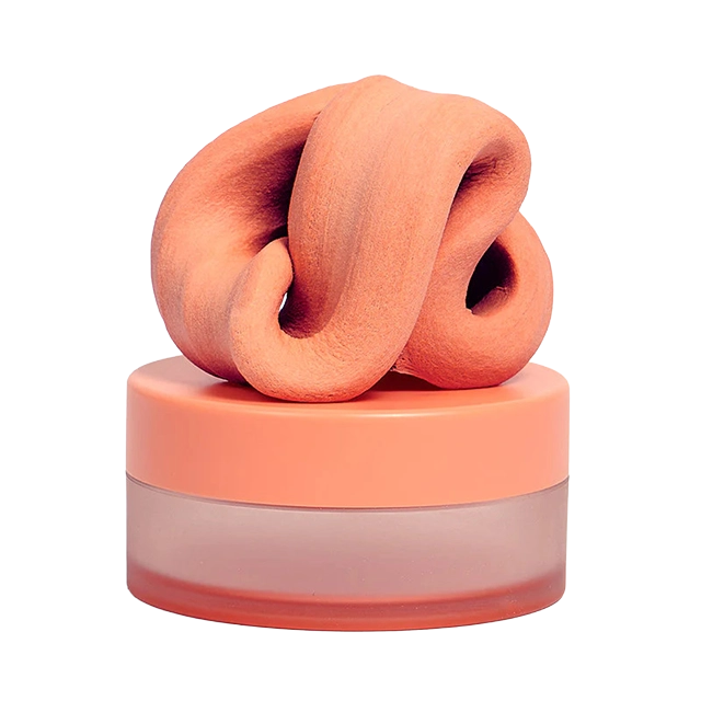 A peach-colored cream in a transparent jar with a swirling top.