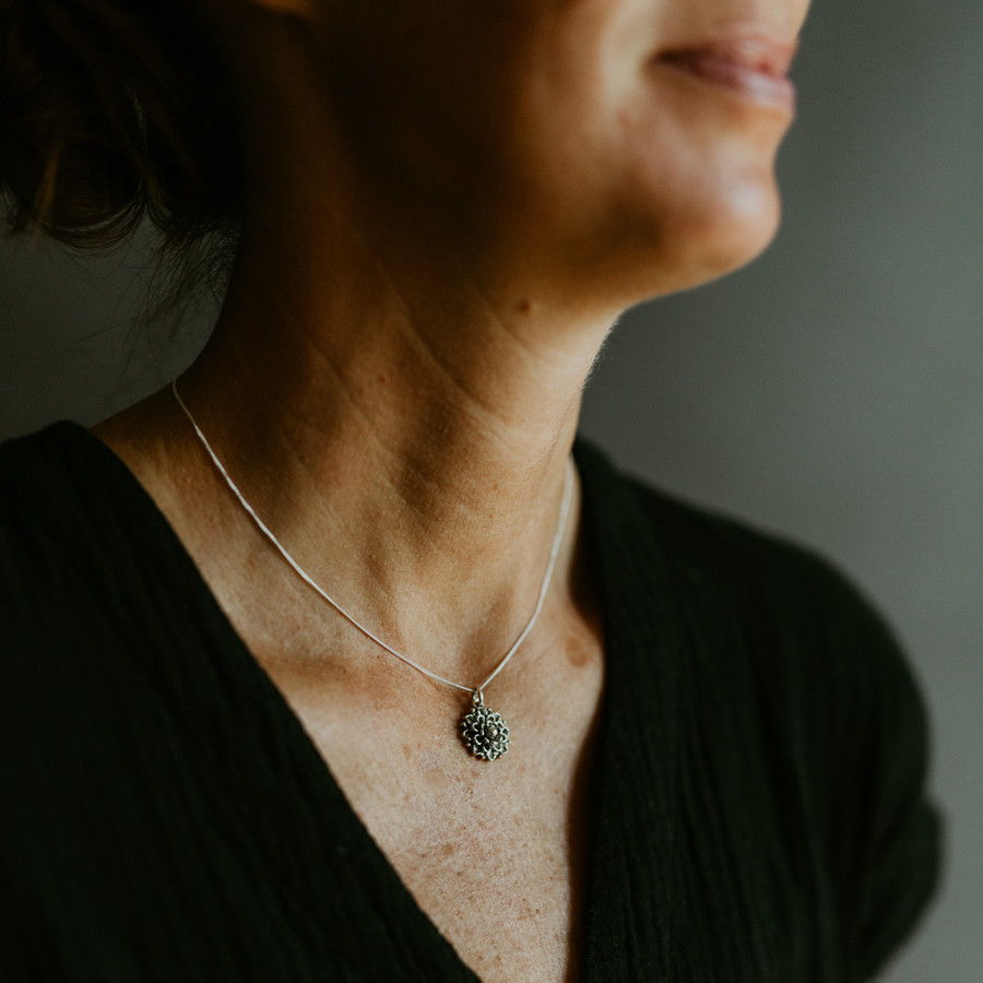 The Mandy Locket flower pendant on a light flat cable chain