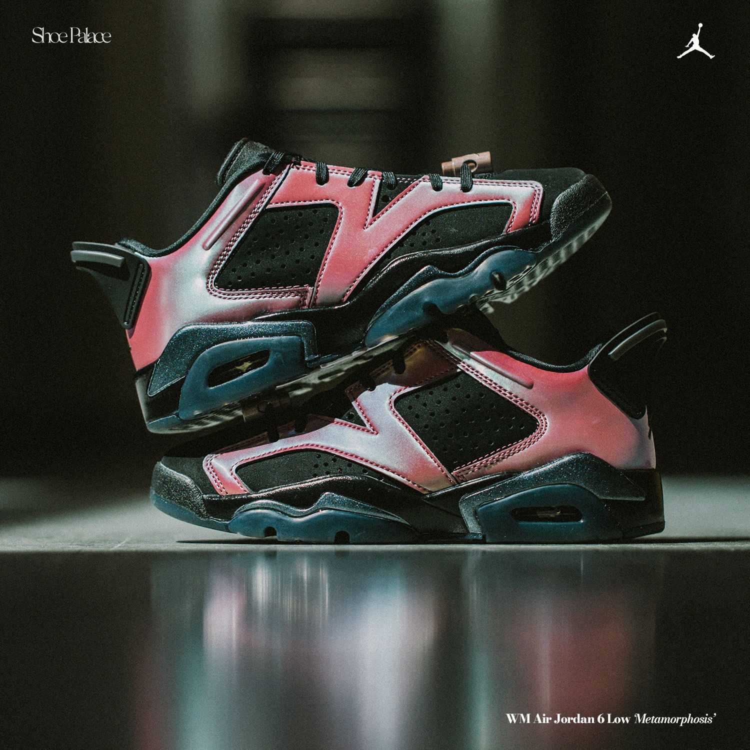 A pair of pink and black Jordan sneakers on a surface.