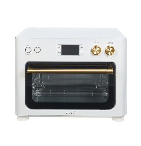 White oven with gold knobs and a transparent glass door.