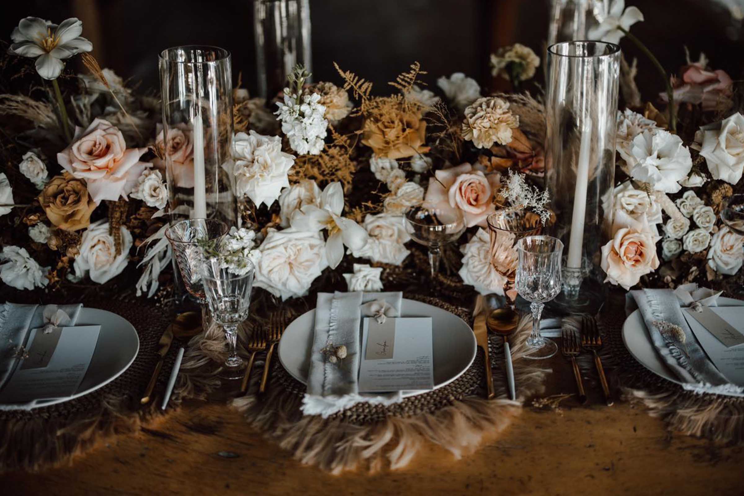 Rustic wooden tables are set with elegant white tablecloths,