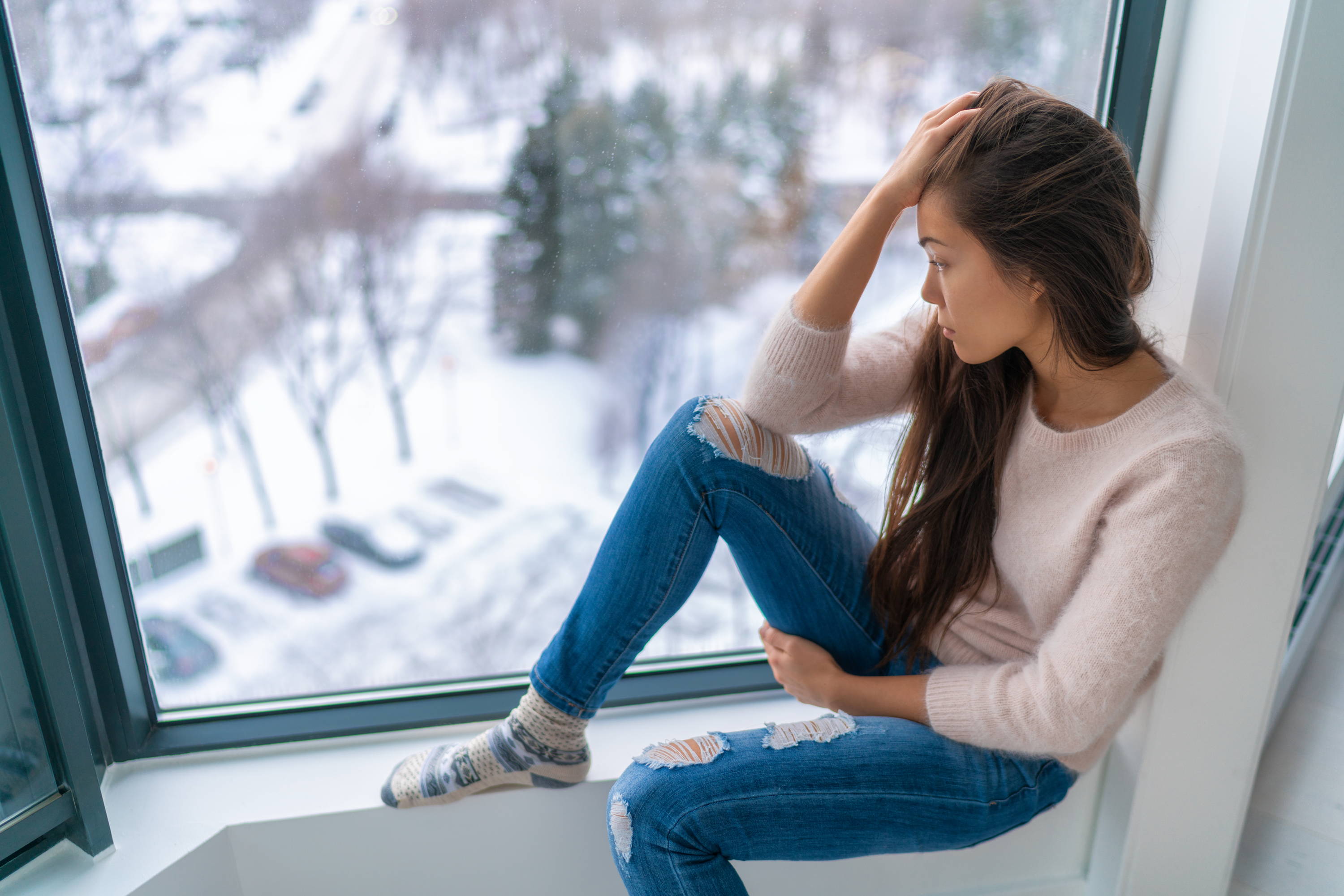 sad girl looking out window|what is seasonal affective disorder SAD |more than just the winter blues