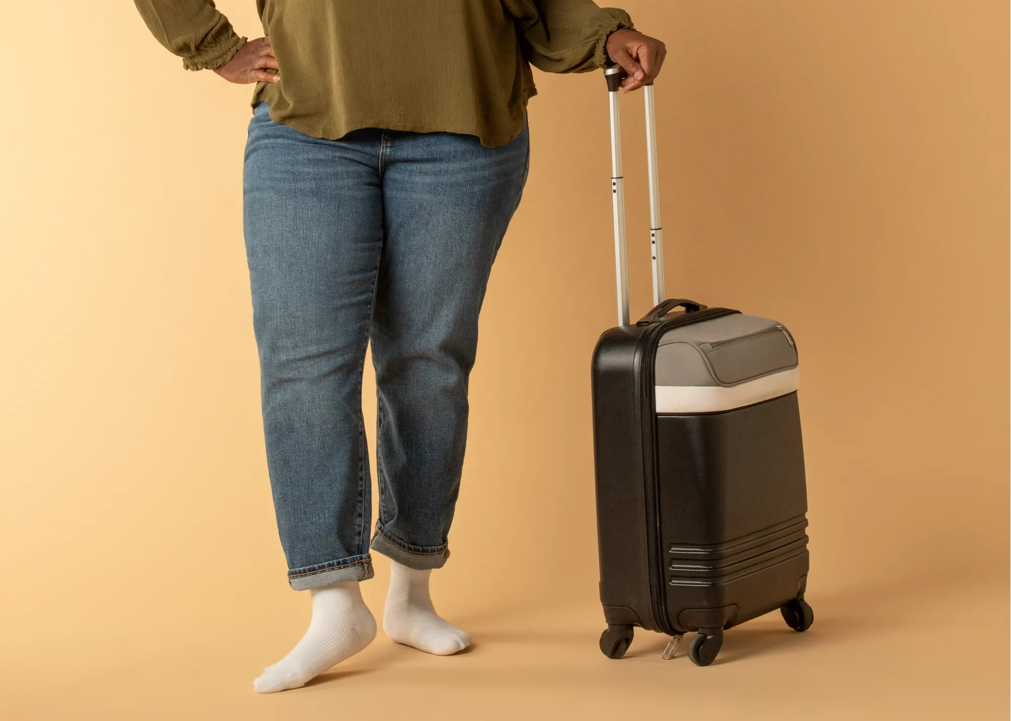 woman wearing Therafirm compression socks, woman holding luggage, woman traveling