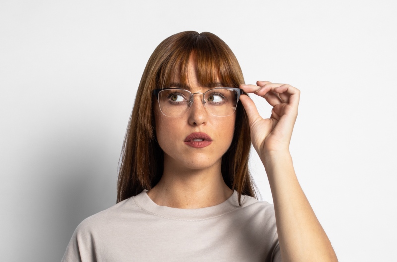 Squared face woman wearing Enchanted Silver, metal cat-eye glasses, on awhite background