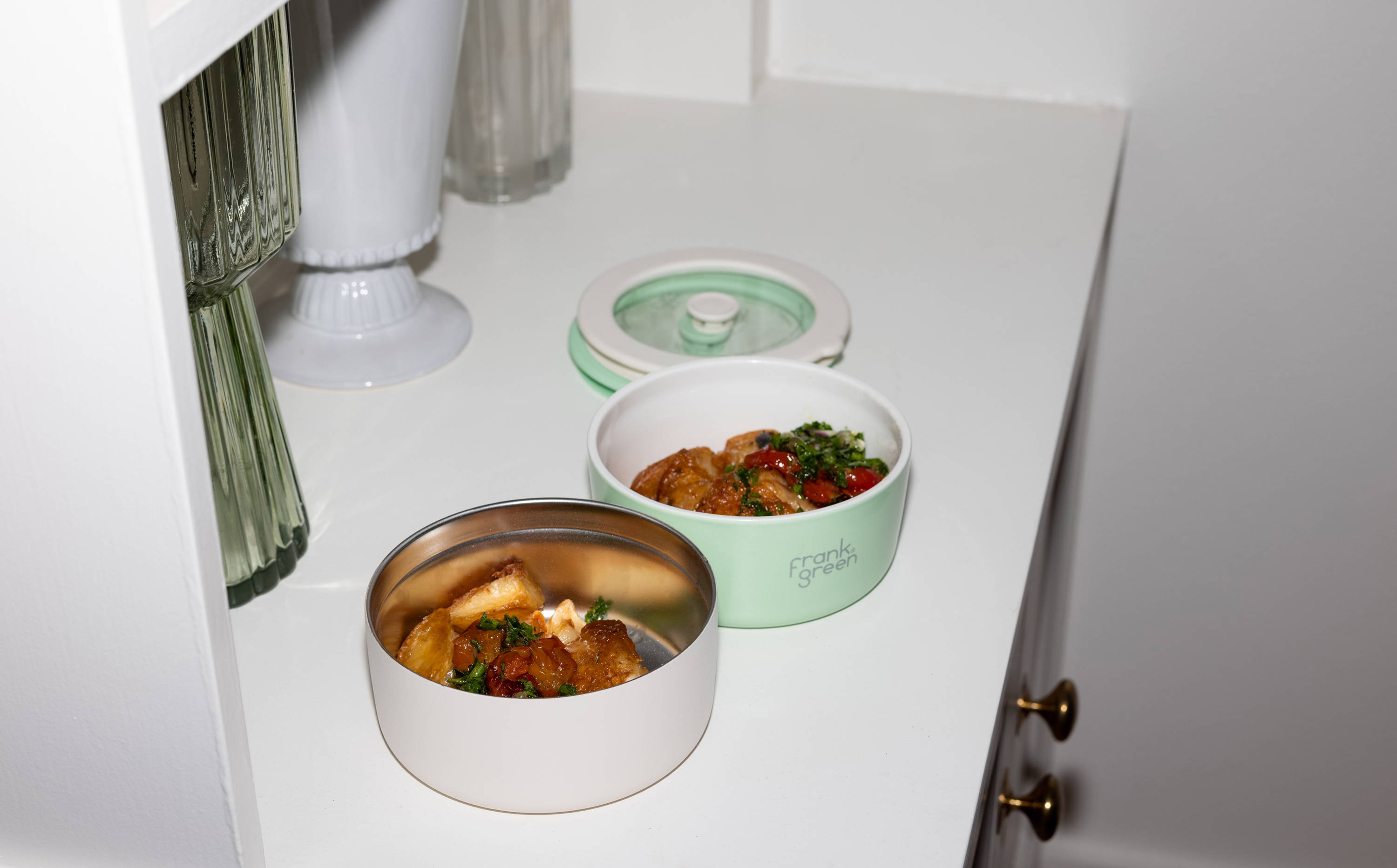 leftovers from club sup are placed in stainless steel and porcelain bowls for guests to take as leftovers