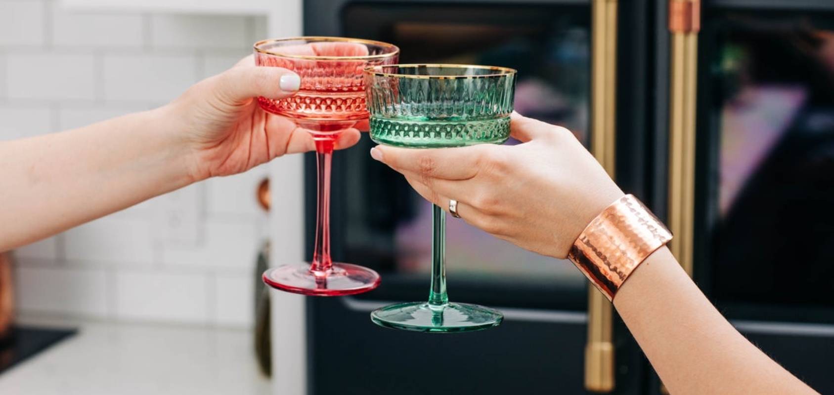 Women toasting glasses in front of Cafe Appliances