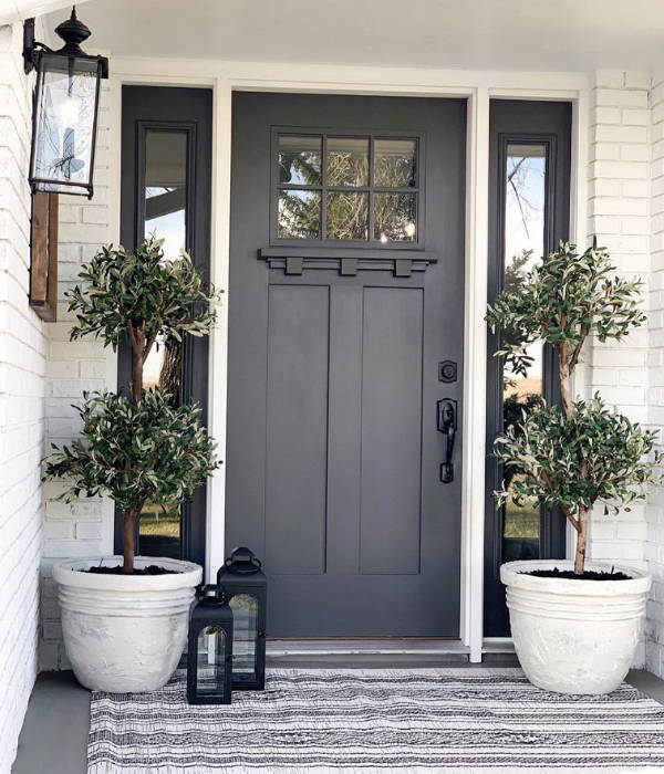 Two artificial olive trees from Nearly Natural decorated next to entrance door