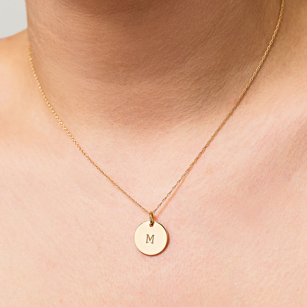 personalized solid gold initial necklace with M worn around neck
