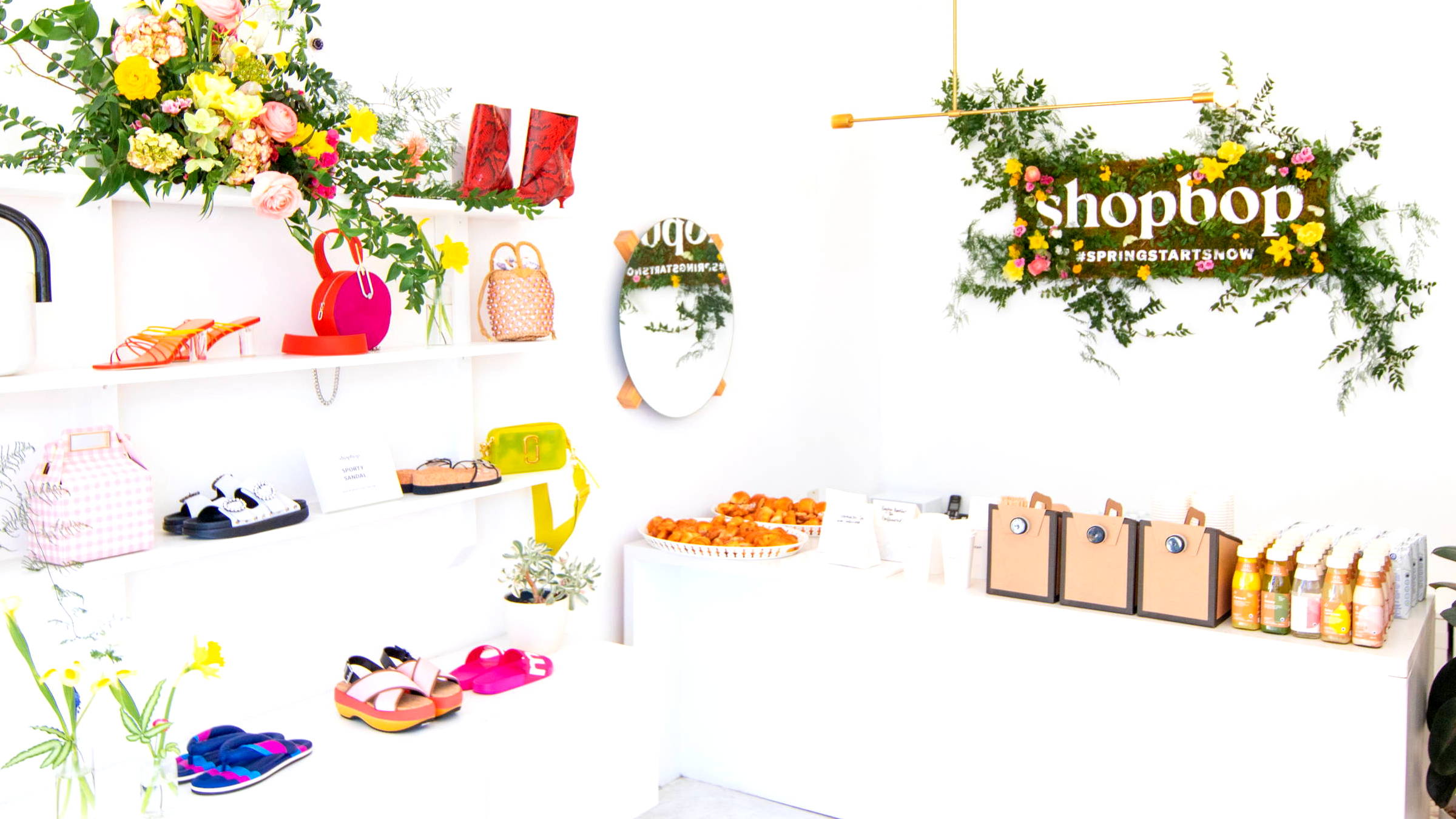 Bright Spring Arrangement and Floral Signage in retail store Shopbop