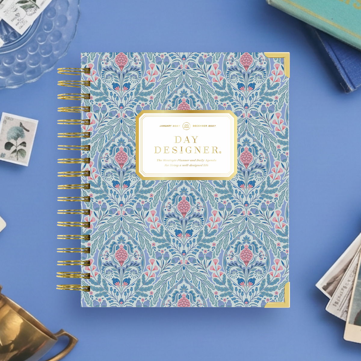 2027 day designer planner featuring blue and pink block print on a blue background