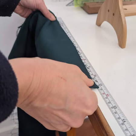 Measuring a piece of fabric on the measuring tape