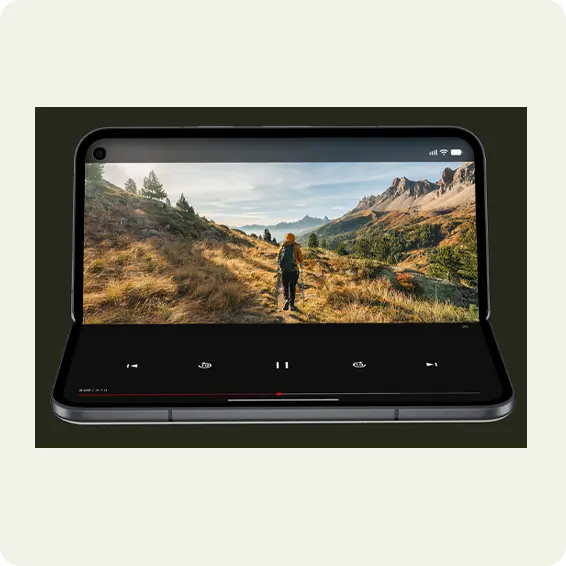 A smartphone displaying a nature scene with a person walking.