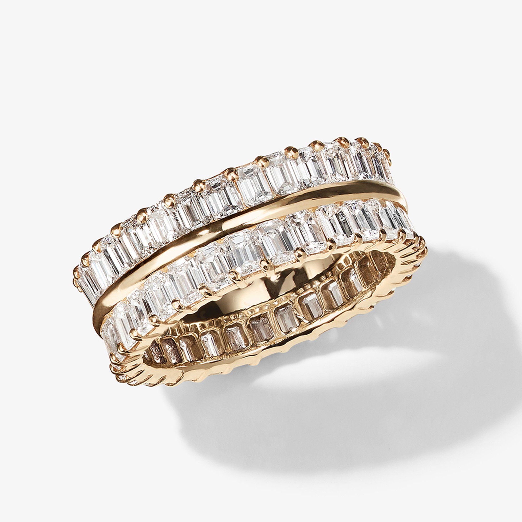 Two elegant gold rings with sparkling clear gemstones.