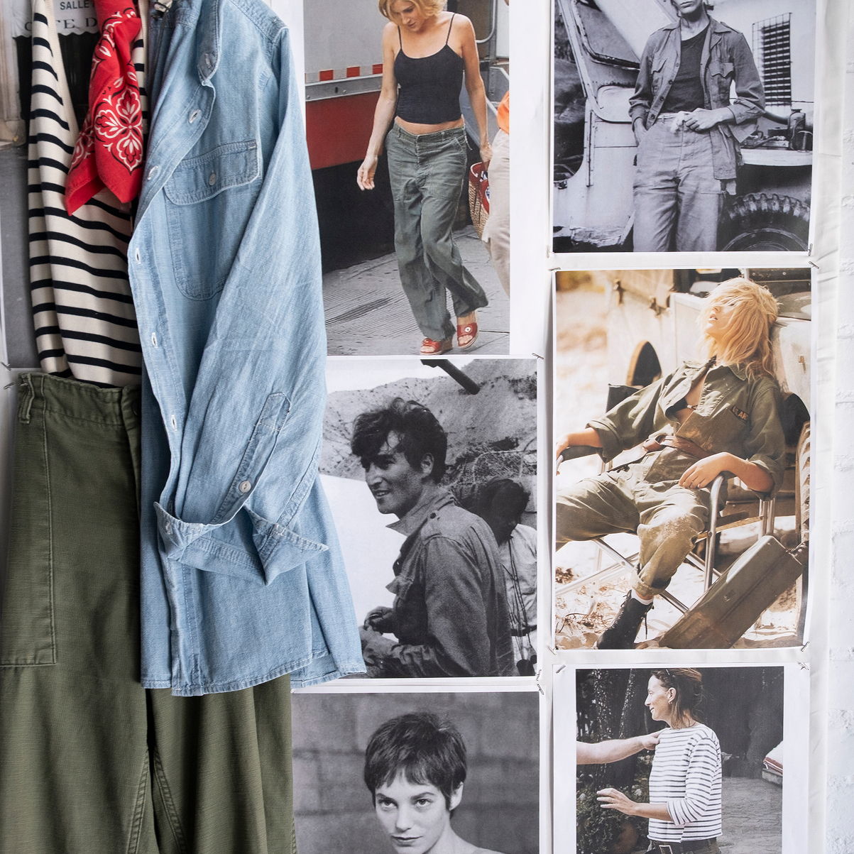 Clothing items displayed with black and white photos on a wall.