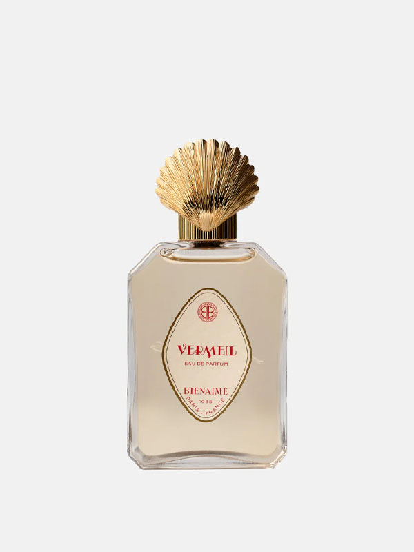 Perfume bottle with a golden shell-shaped cap and elegant design.