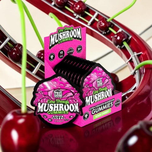 Mushroom gummies packaging displayed with cherries and a colorful background.