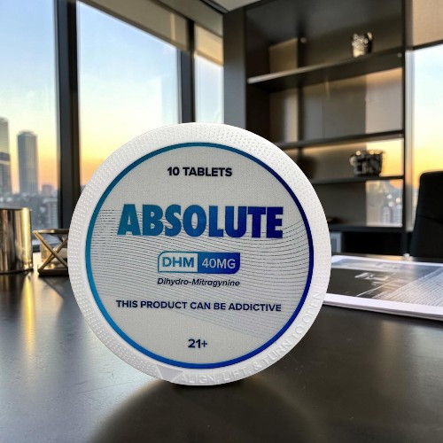 Container of ABSOLUTE tablets with a city view in the background.
