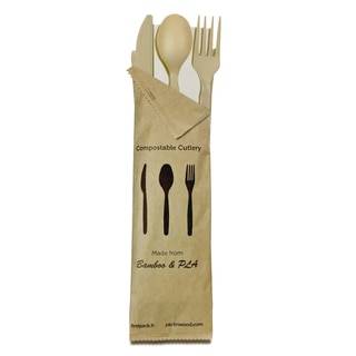A Bamboo Fiber CPLA fork, knife,  spoon, and napkin in a paper bag