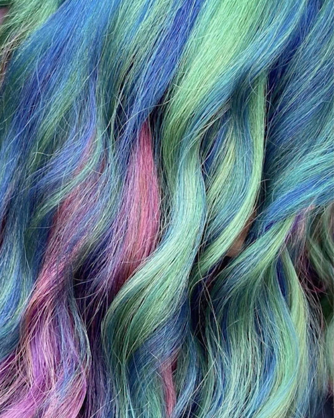 Image of Prism dyed hair in the colors green blue and purple