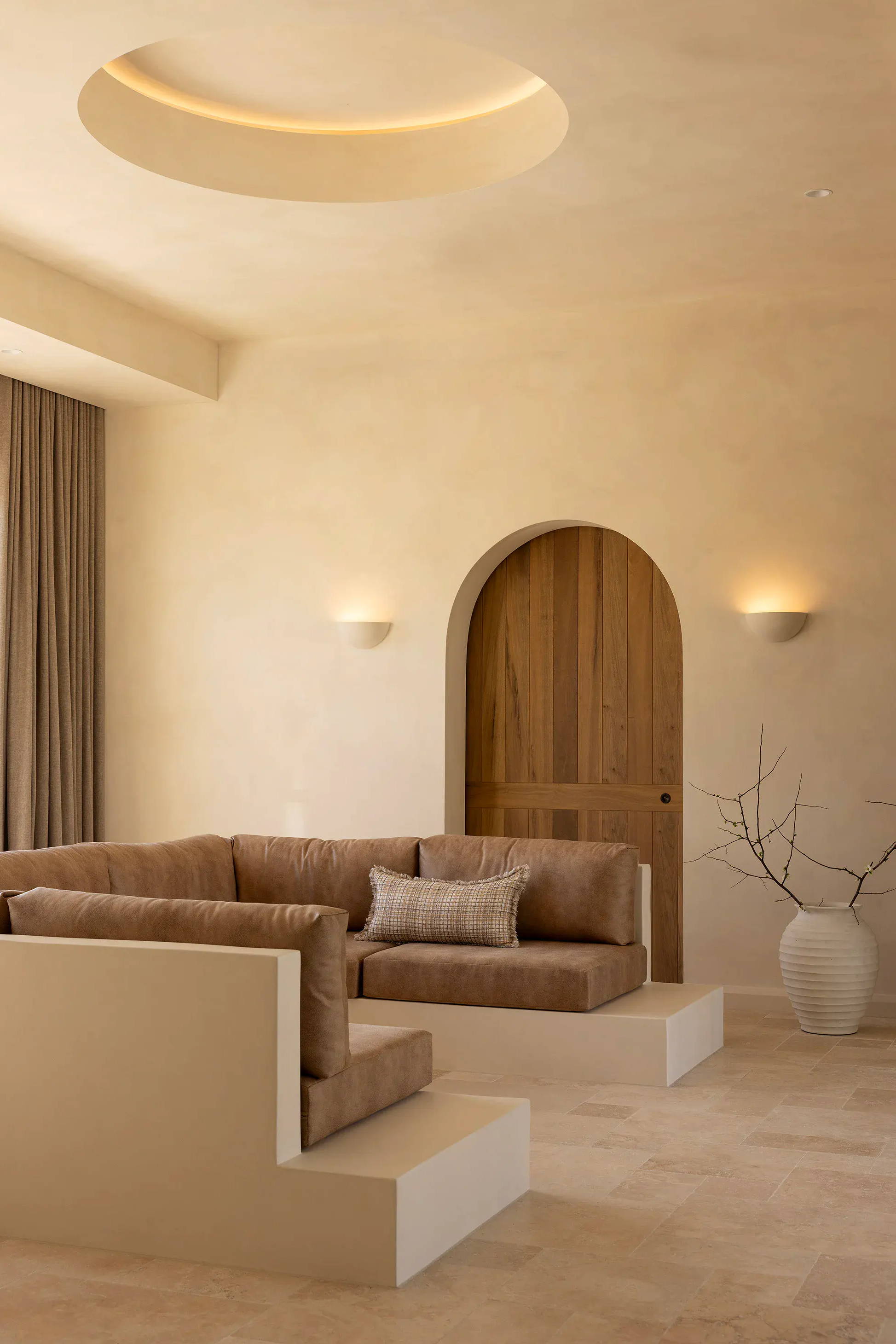 Modern living room with minimalist decor and earthy tones.
