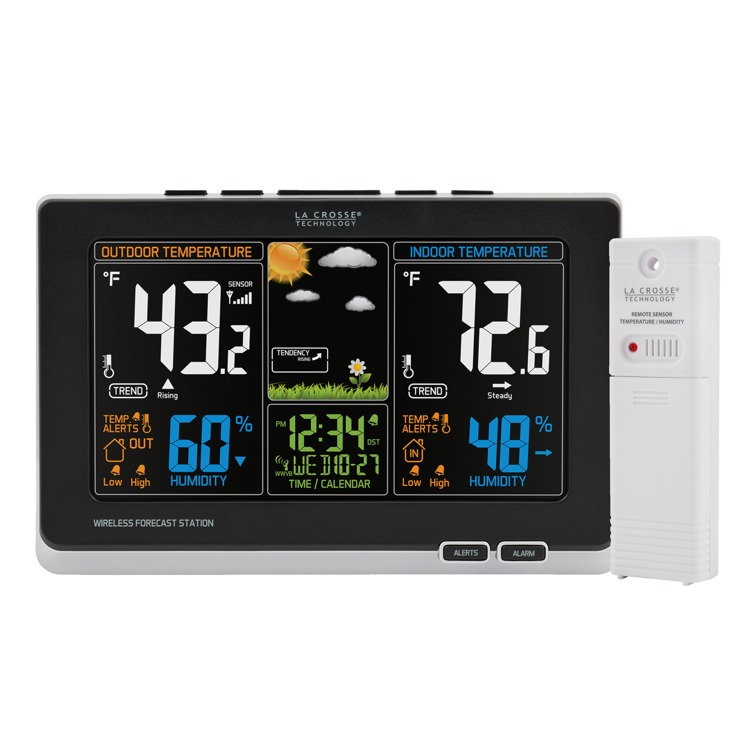 Weather station on books beside a vase of yellow flowers.