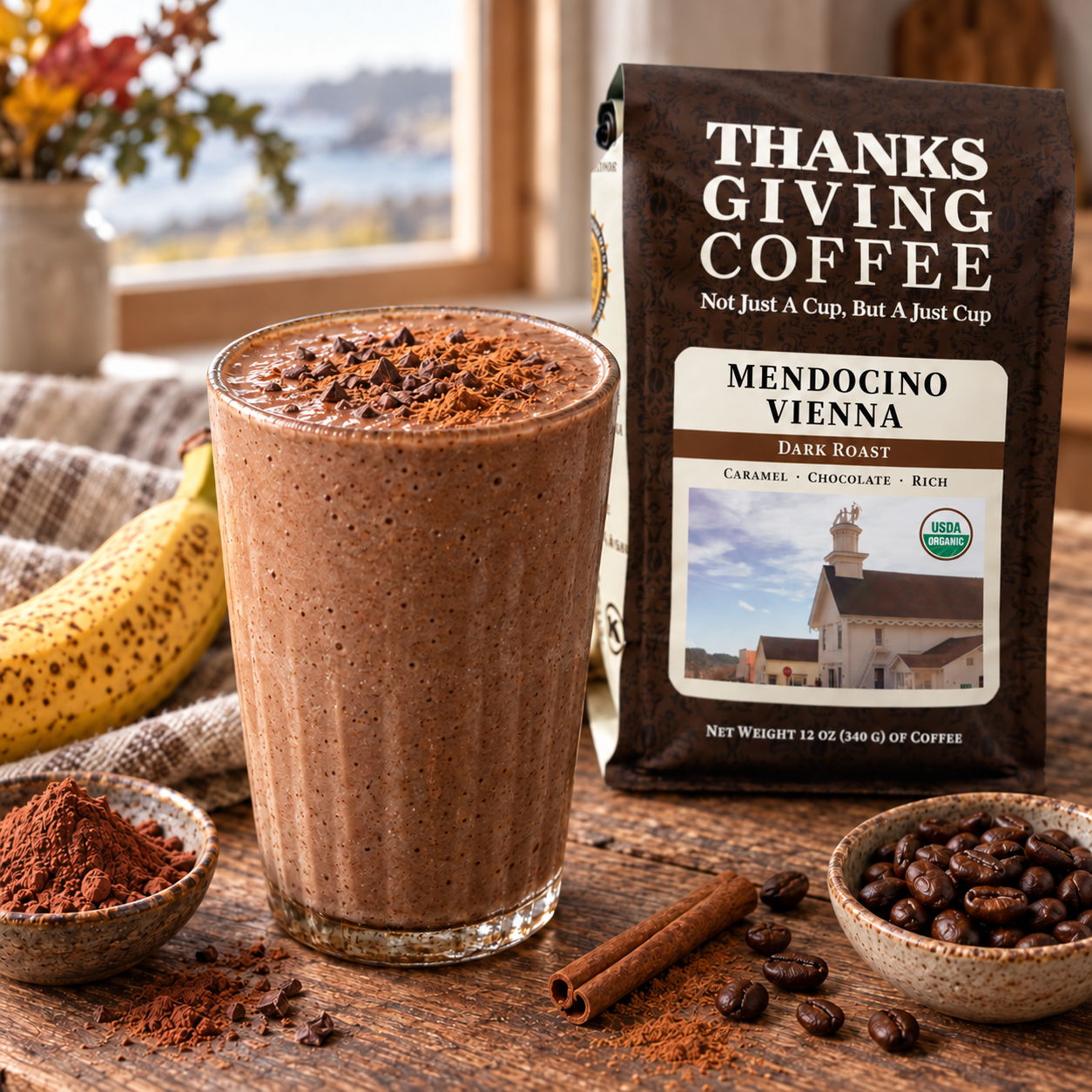 A smoothie glass with coffee, banana, and a coffee bag in the background.