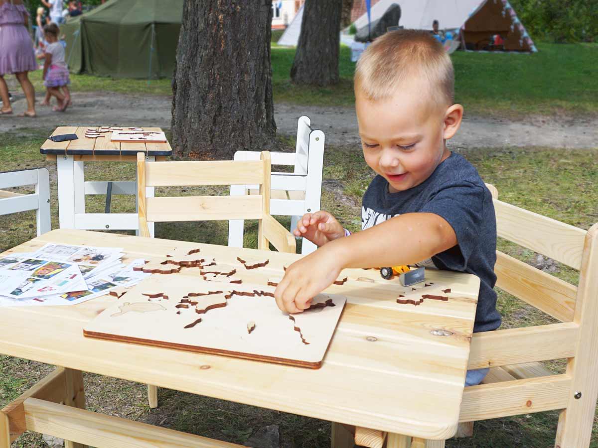  Boy playing with a puzzle at the table by WholeWoodPlayhouses