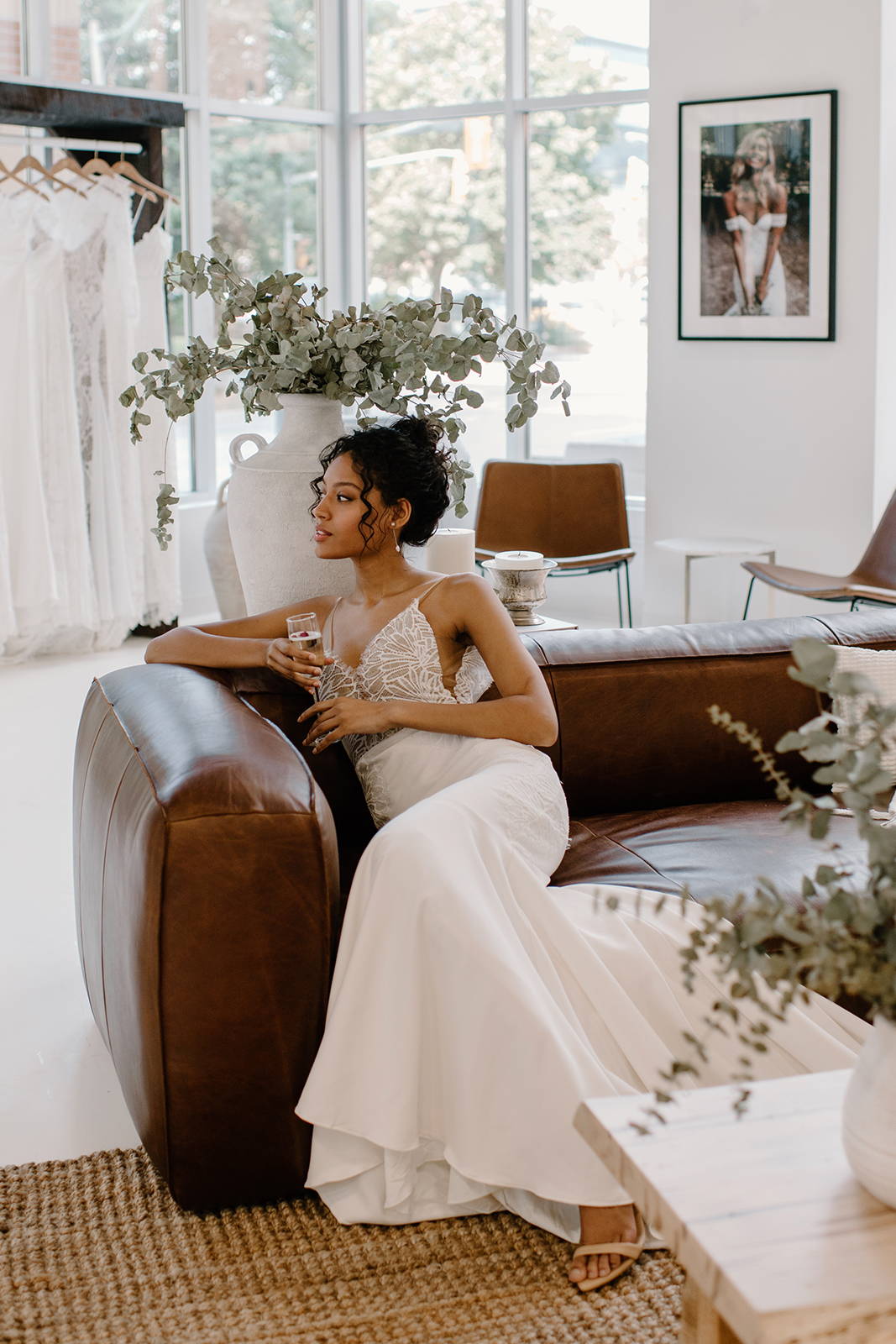 Bride sitting on the couch, sipping champagne during her bridal appointment.