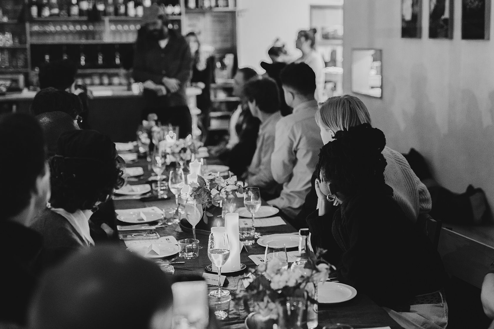 A group of people seated at a dining table in a restaurant.