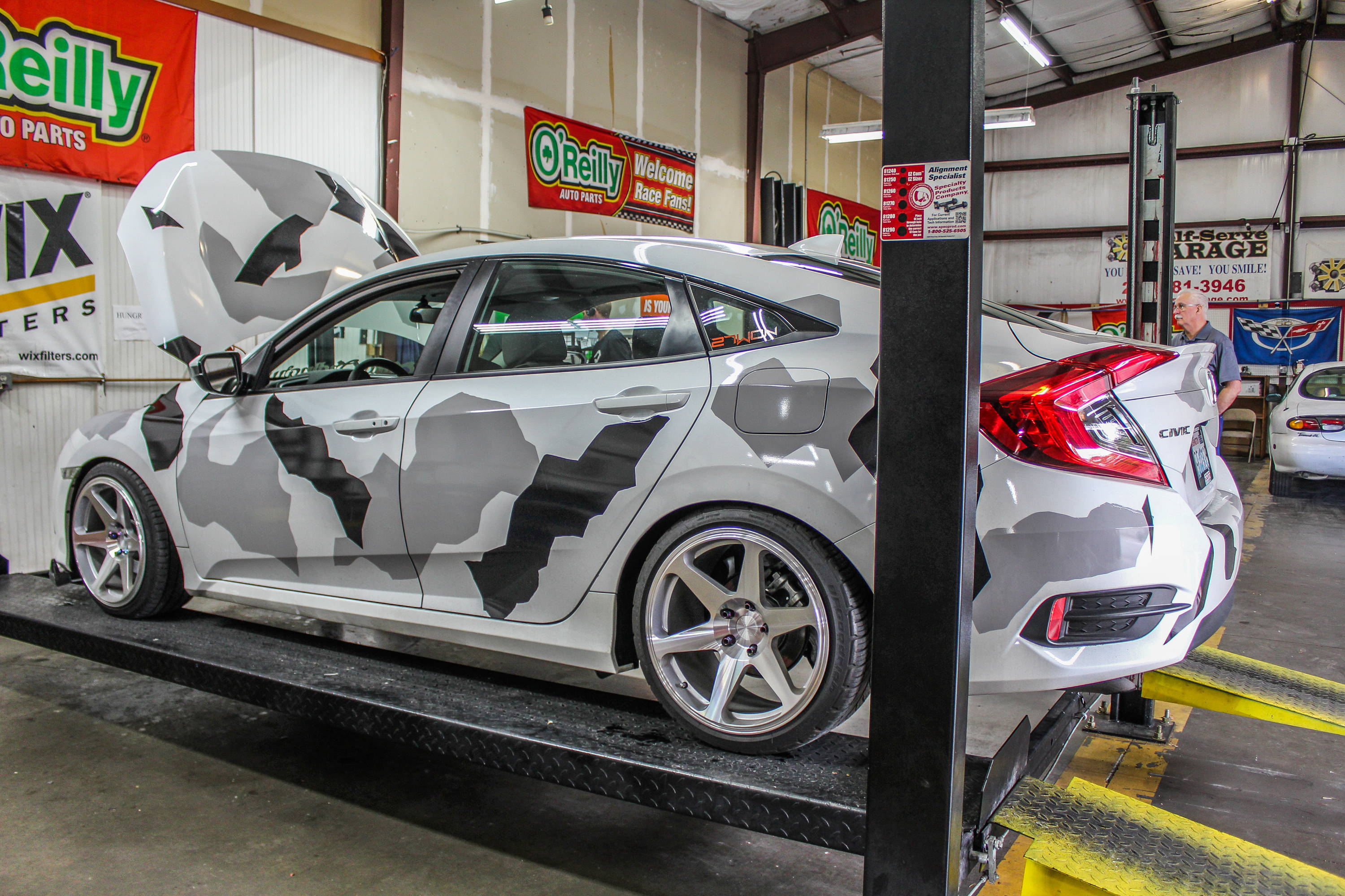 2017 Honda Civic - Honda Civic on car lift at a self serve garage.