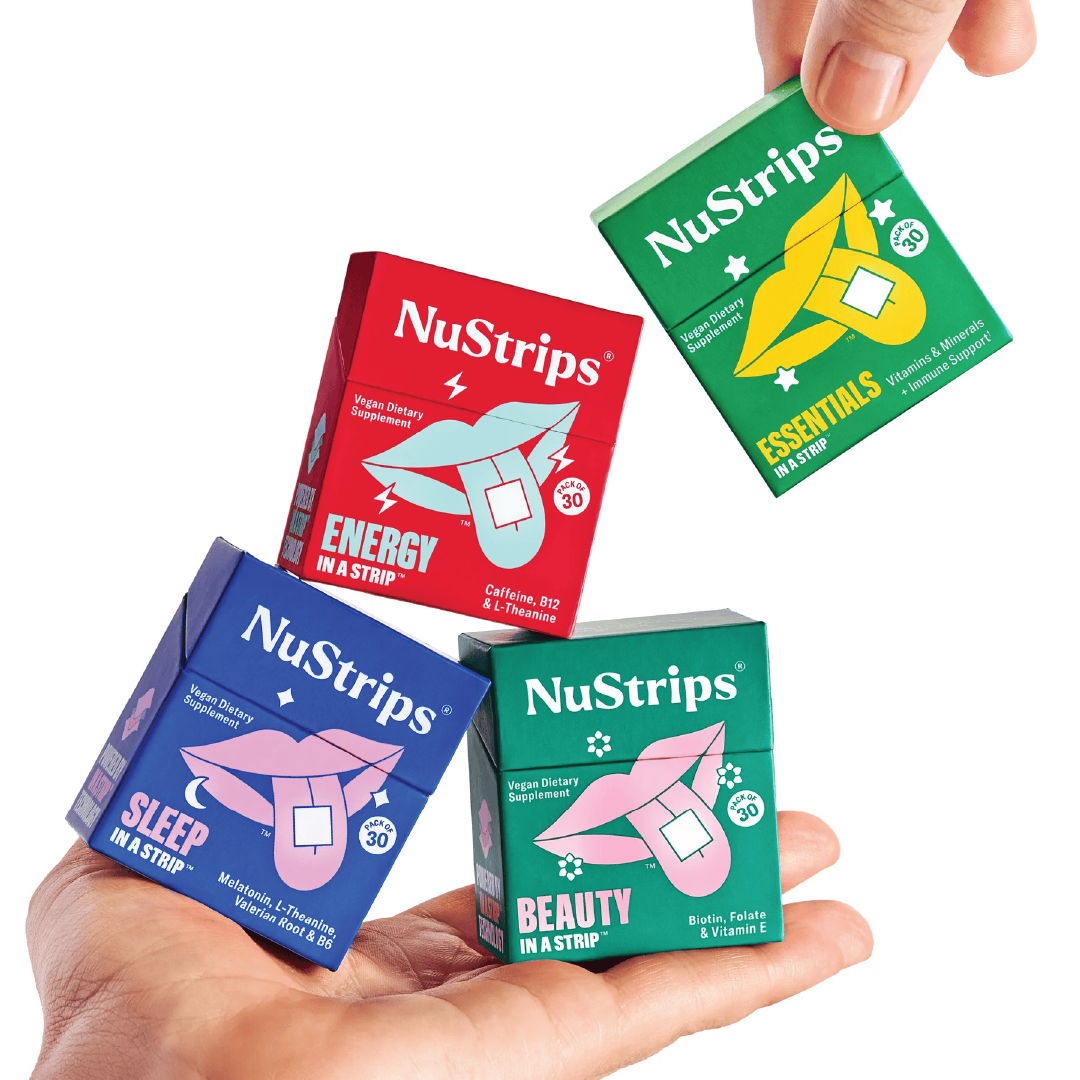 Four boxes of NuStrips in a person's hand.