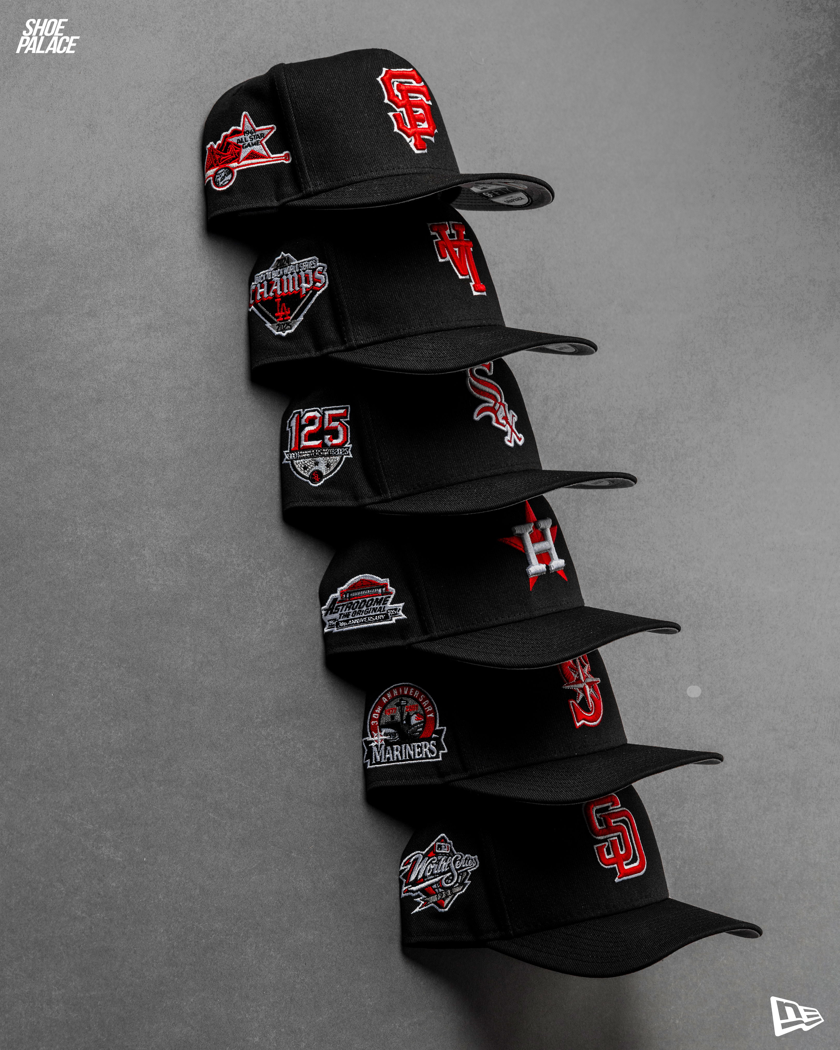 A stack of black caps with various embroidered logos.