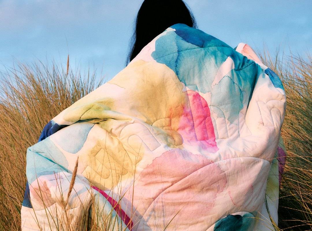 sunshine outdoor blanket wrapped around model